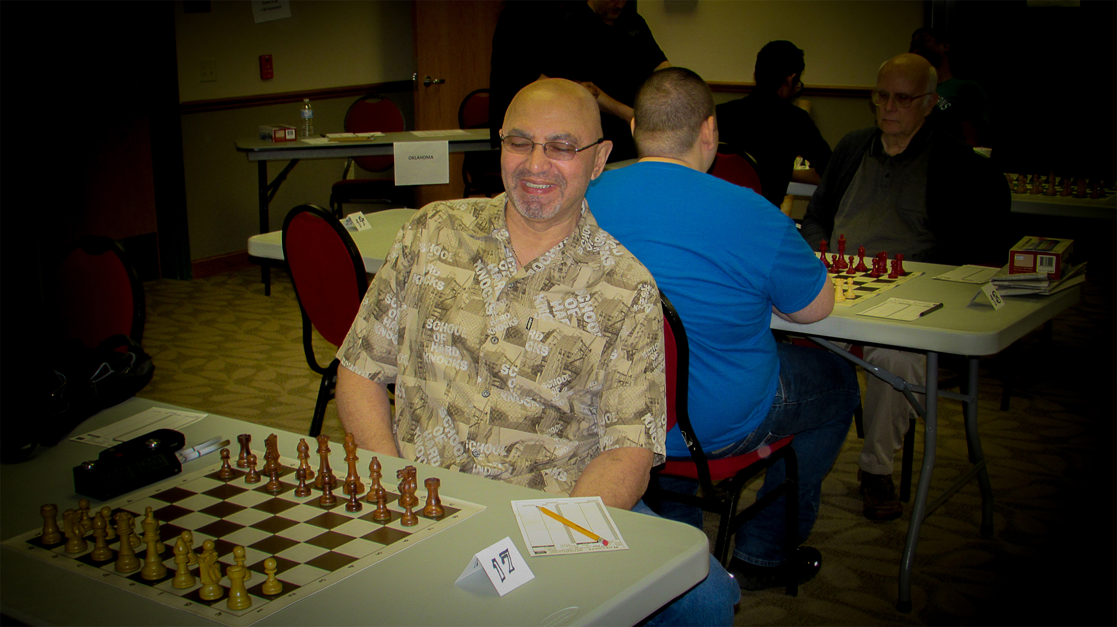 Playing in his second RRSO, Jimmy Nazario waits on Board 17.  Mr. Nazario is ranked in the 76th Percentile for all USA chess players.  In Oklahoma he is ranked in the Top 100 at Number 89.  Photo by Mike Tubbs.